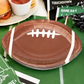 Football shaped brown paper plates for game day parties and tailgate celebrations