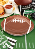 Football shaped brown paper plates for game day parties and tailgate celebrations