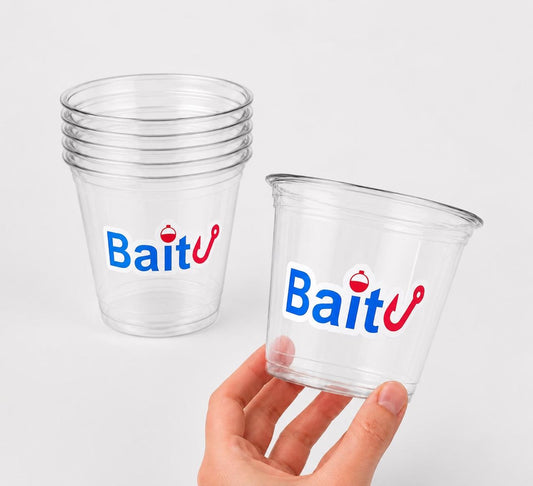 May include: Clear plastic cups with the word "Bait" in blue and red lettering. One cup is held by a hand. The cups are stacked in a pile of five. The logo includes a fishing hook and a bobber.