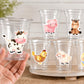 May include: Clear plastic cups decorated with farm animal stickers, including a cow, pig, horse, chicken, sheep, and chick. The stickers are colorful and cartoon-like, with a white background.