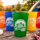 May include: A set of five colorful plastic stadium cups in orange, blue, green, yellow, and red. Each cup features a white circular graphic with a campfire illustration, pine trees, and the text "Fires, Friends, Fun, Camping Crew".